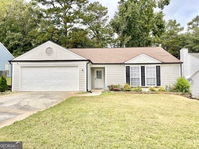 ranch-style house featuring a garage and a front yard