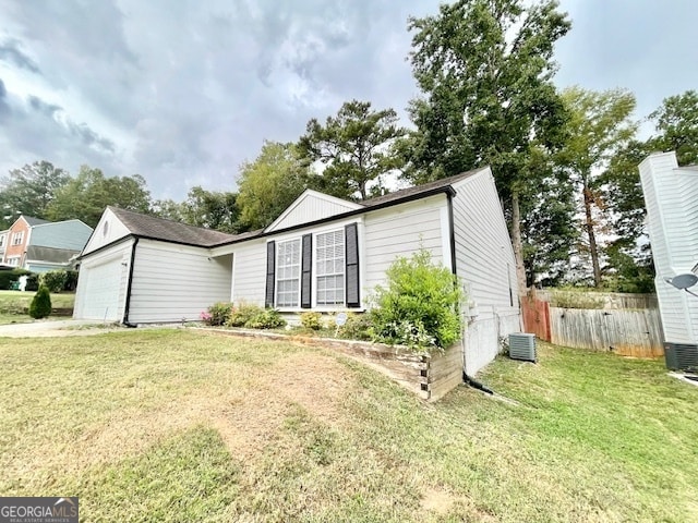 exterior space with central AC and a garage