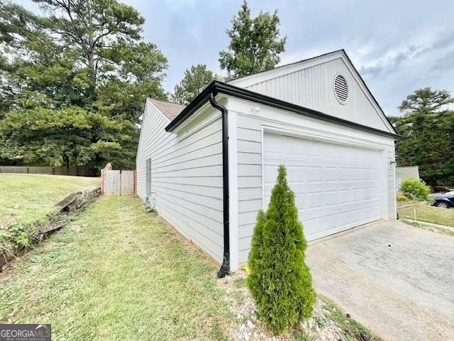 view of side of property featuring a yard and a garage