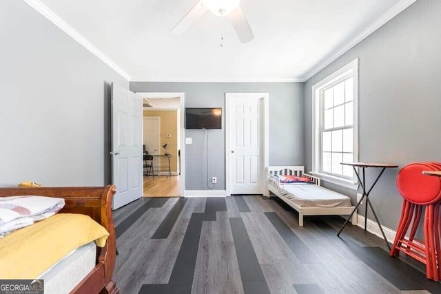 bedroom featuring ornamental molding, ceiling fan, and dark wood-type flooring