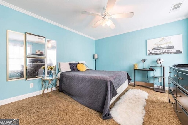 carpeted bedroom with ornamental molding and ceiling fan