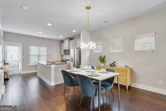 dining room featuring dark hardwood / wood-style flooring and a notable chandelier