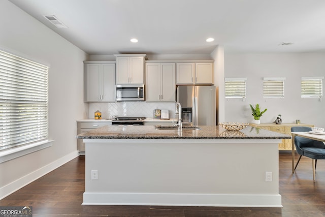 kitchen featuring stainless steel appliances, plenty of natural light, sink, and dark hardwood / wood-style flooring