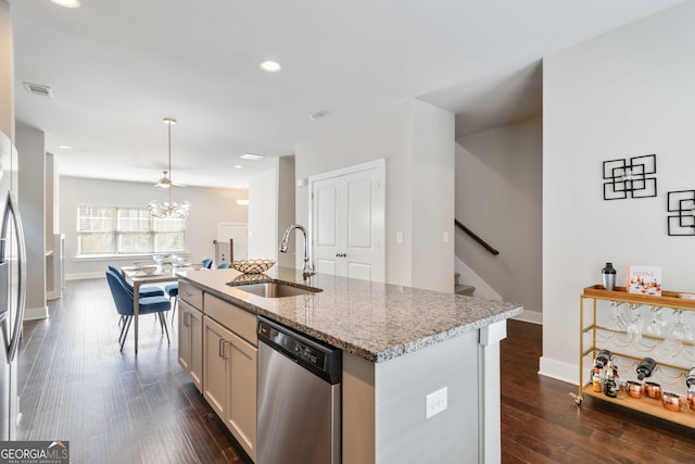 kitchen with dark wood-type flooring, an island with sink, dishwasher, pendant lighting, and sink