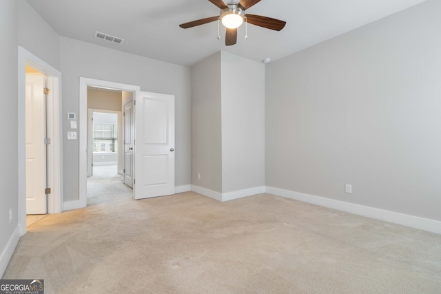 carpeted spare room with ceiling fan