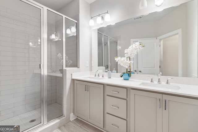 bathroom featuring vanity and a shower with door