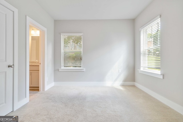 unfurnished bedroom with carpet and ensuite bath