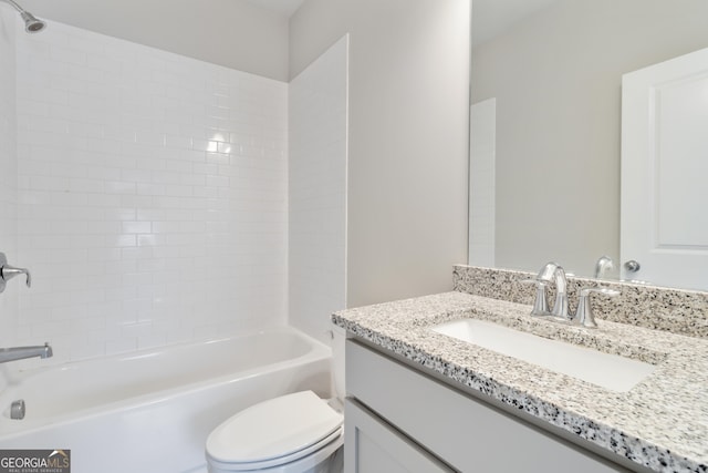 full bathroom featuring tiled shower / bath combo, vanity, and toilet