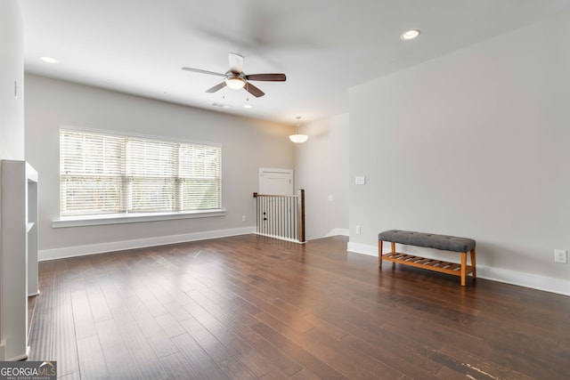 interior space with dark hardwood / wood-style floors and ceiling fan