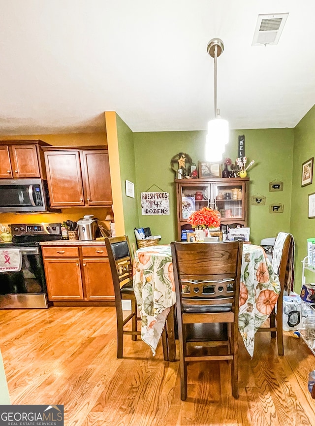 dining room with light wood-type flooring