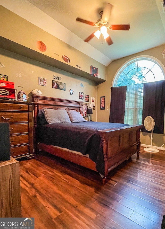 bedroom with lofted ceiling, ceiling fan, and dark wood-type flooring