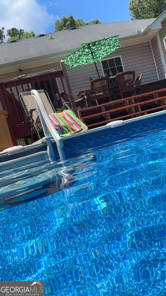 view of swimming pool with a wooden deck