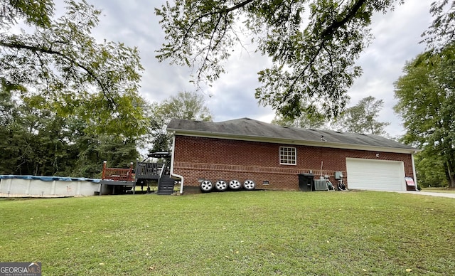 view of property exterior with a yard, a garage, a swimming pool side deck, and central AC unit