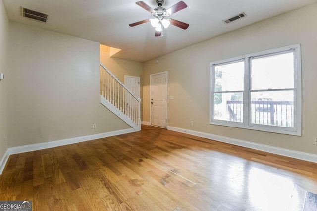 empty room with ceiling fan and light wood-type flooring