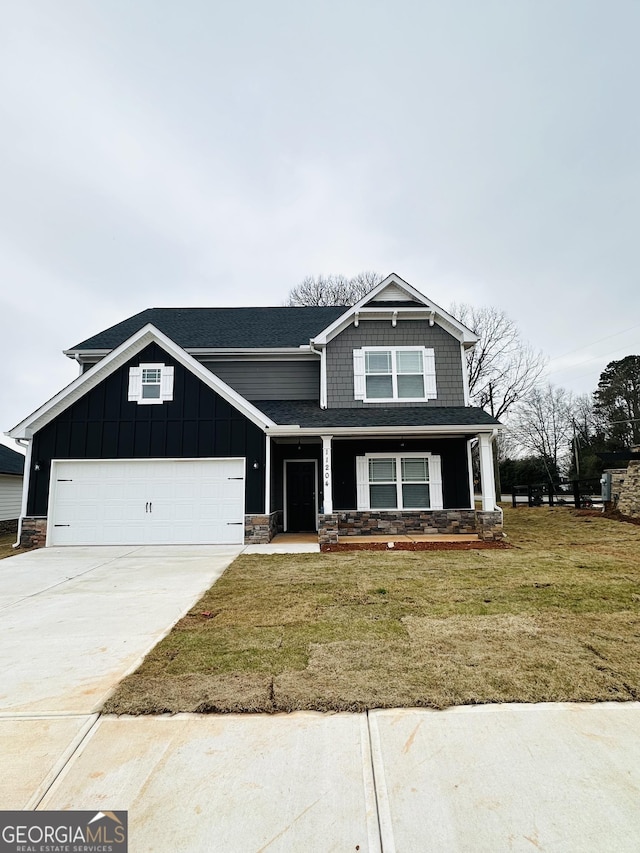 craftsman-style house featuring concrete driveway, stone siding, board and batten siding, and a front yard