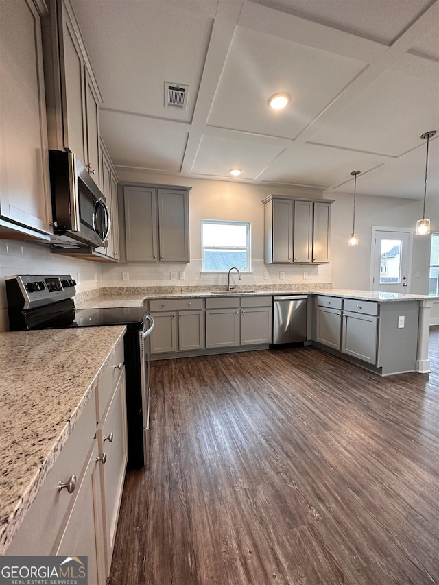 kitchen with stainless steel appliances, dark hardwood / wood-style flooring, sink, and hanging light fixtures