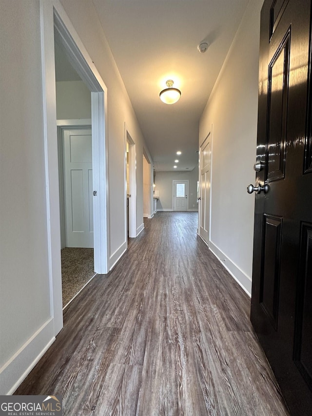 corridor featuring dark hardwood / wood-style floors