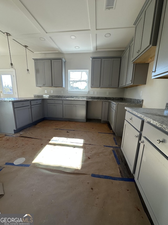 kitchen featuring gray cabinets, a wealth of natural light, and decorative light fixtures