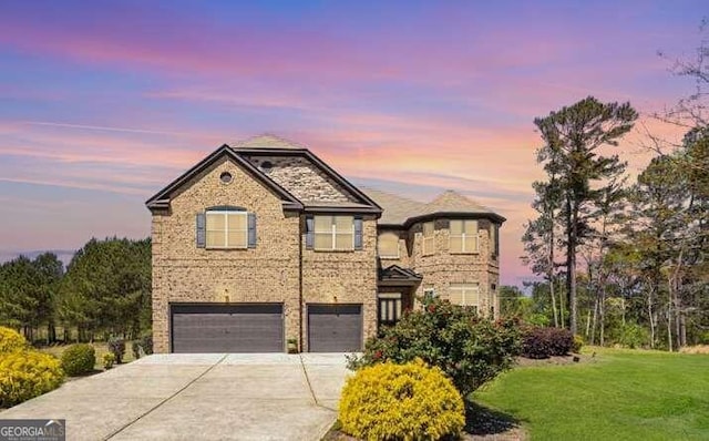 view of front of home with a lawn and a garage