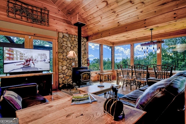 interior space featuring wood ceiling, lofted ceiling, hardwood / wood-style floors, and a wood stove