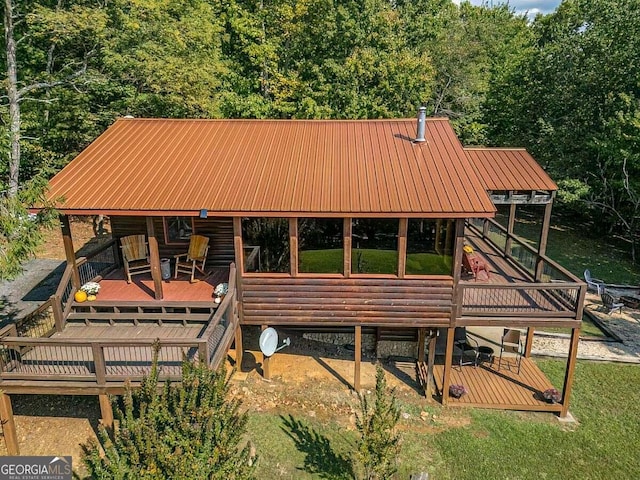 view of property's community featuring a wooden deck and a wooded view