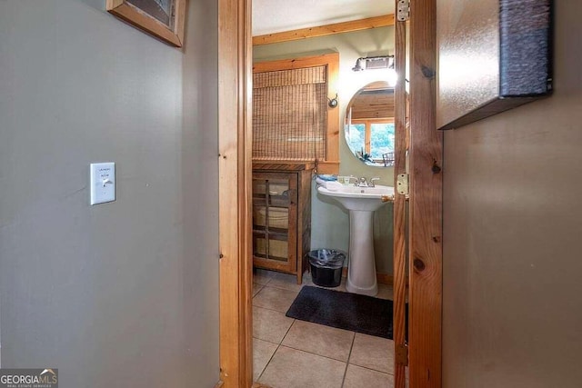 bathroom featuring tile patterned floors and a sink