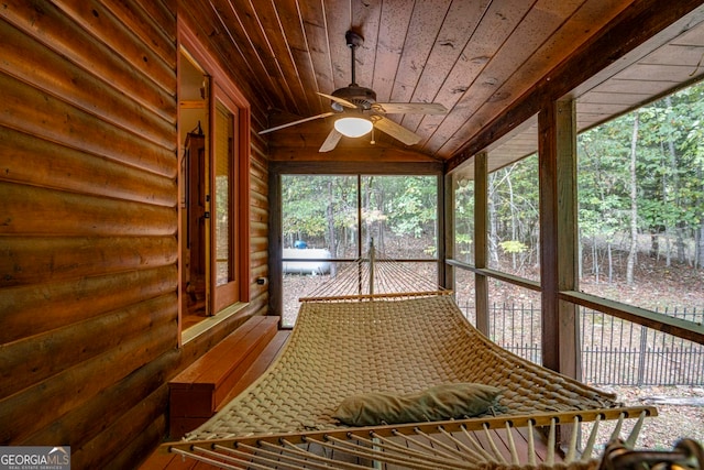 unfurnished sunroom featuring wooden ceiling, vaulted ceiling, and ceiling fan