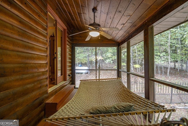 unfurnished sunroom featuring wood ceiling, vaulted ceiling, and ceiling fan