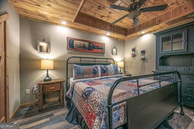 bedroom with wooden ceiling, wood finished floors, and baseboards