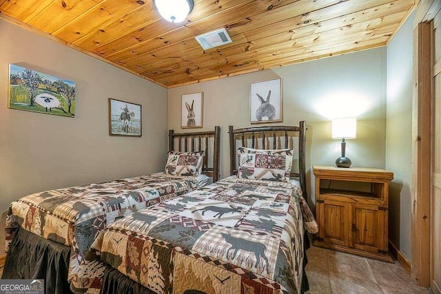 bedroom with wooden ceiling and light tile patterned floors