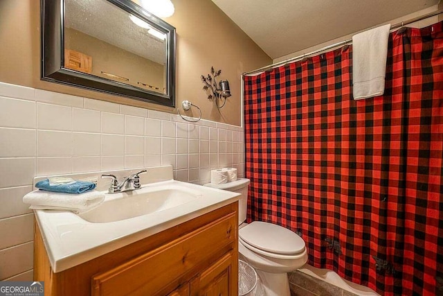 full bathroom with wainscoting, toilet, a shower with shower curtain, vanity, and tile walls