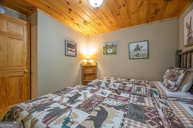 bedroom featuring vaulted ceiling and wood ceiling