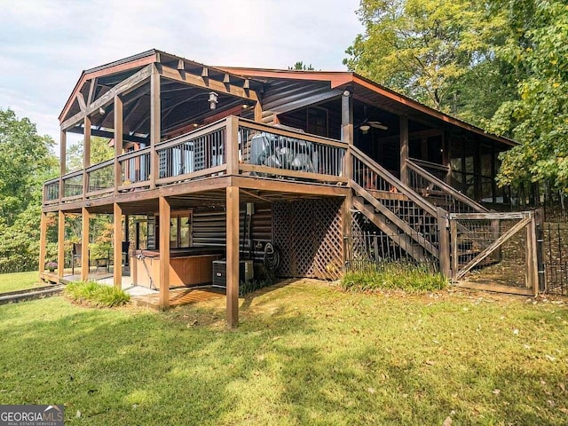 rear view of property with central AC unit, a wooden deck, and a lawn