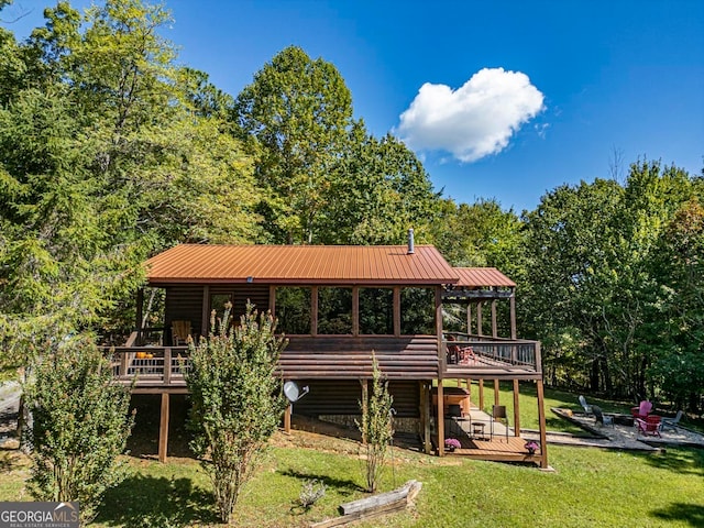 exterior space featuring a wooden deck and a lawn