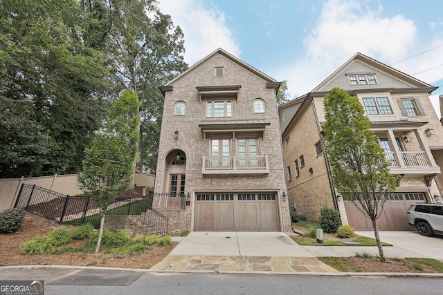 view of front of property featuring a garage and a balcony