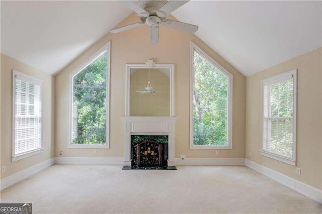 unfurnished living room with ceiling fan, lofted ceiling, and light carpet