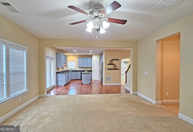 interior space featuring carpet floors and ceiling fan