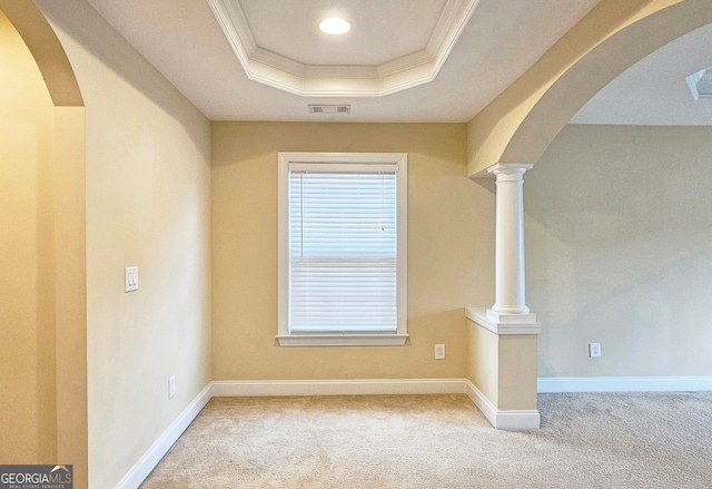 interior space with carpet, crown molding, and a raised ceiling