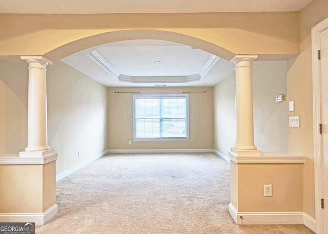 unfurnished living room featuring ornamental molding, light colored carpet, and a raised ceiling