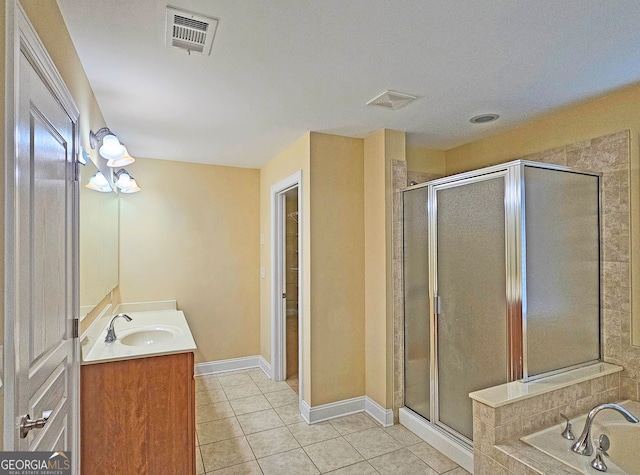 bathroom with tile patterned flooring, vanity, and separate shower and tub