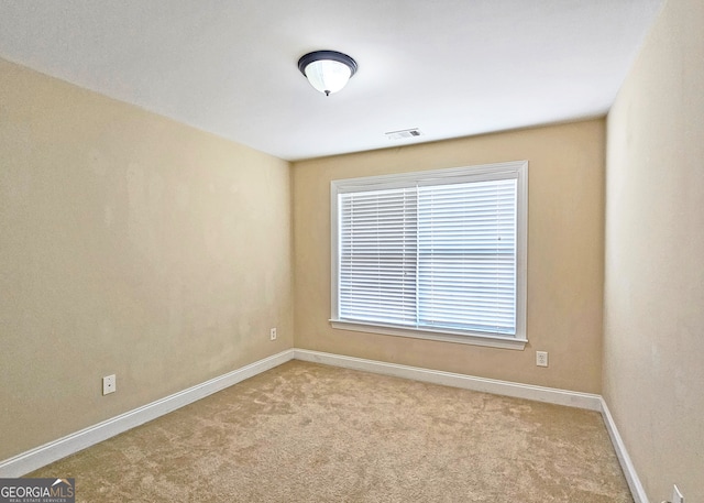 empty room with light colored carpet