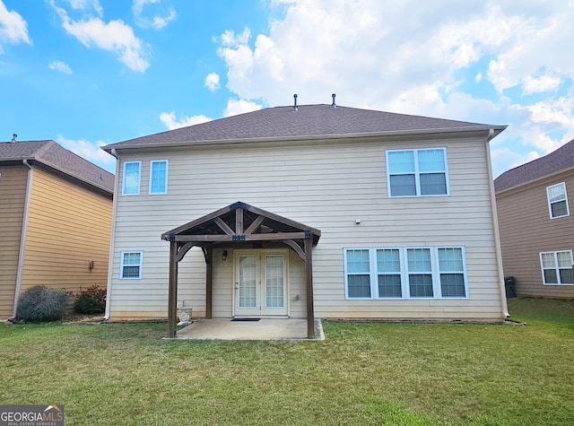 rear view of property featuring a patio area and a yard