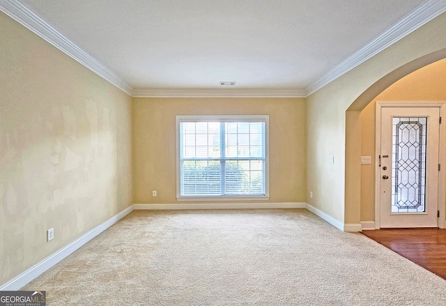 foyer entrance featuring carpet flooring and ornamental molding