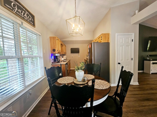 dining room featuring an inviting chandelier, vaulted ceiling, and dark hardwood / wood-style floors