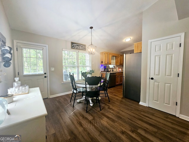 dining room featuring a notable chandelier, sink, and dark hardwood / wood-style flooring