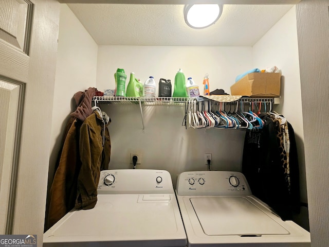 laundry area featuring a textured ceiling and separate washer and dryer