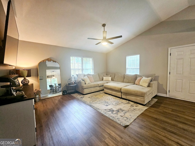 living room featuring vaulted ceiling, ceiling fan, and dark wood-type flooring