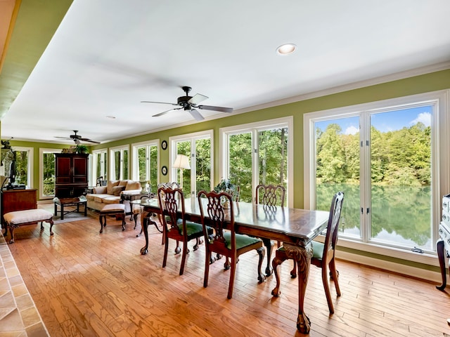 dining room with light hardwood / wood-style flooring, ceiling fan, and ornamental molding