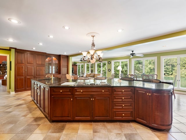 4394 Holly Springs Rd, Pendergrass, GA 30567 - kitchen featuring pendant lighting, a wealth of natural light, stovetop, and a center island with sink