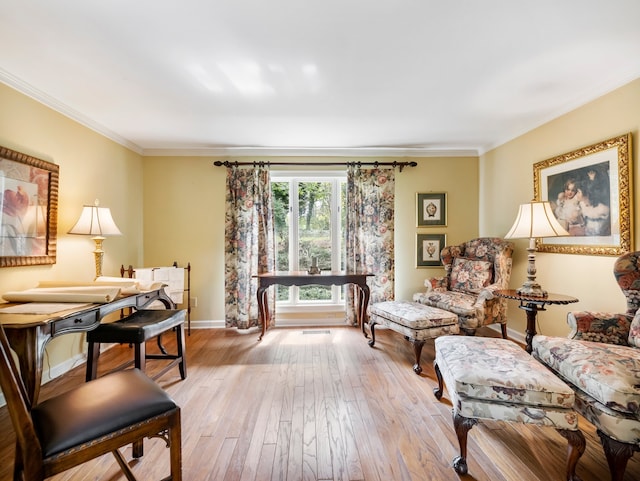 living room with crown molding and light hardwood / wood-style floors